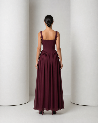 Back of the Solveig burgundy gown, showing the panelled corset and gathered skirt