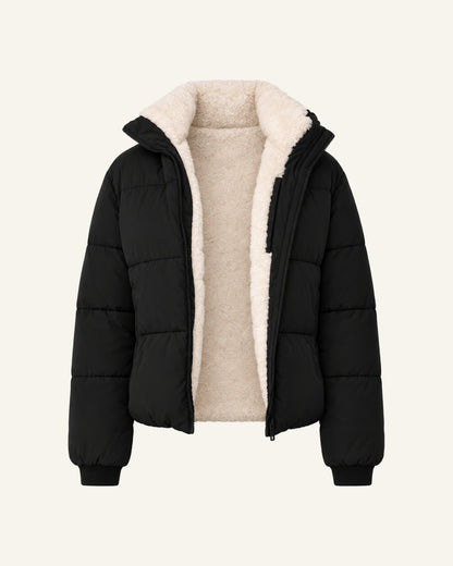 Tove hooded puffer jacket in black, shown open to the cream faux-fur lining