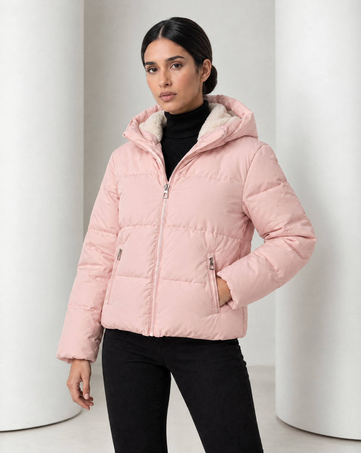 Close view of the Tove puffer in pink, teddy-lined hood resting behind the neck