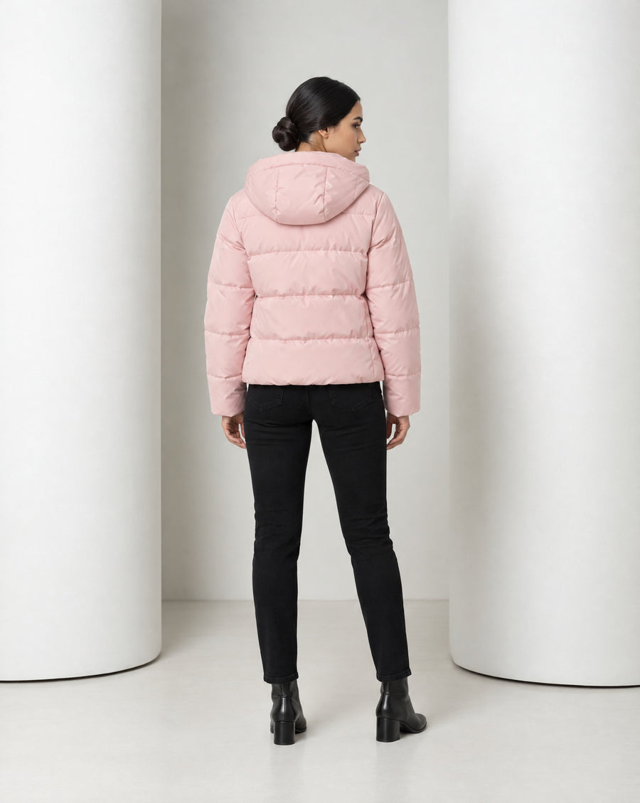Tove hooded puffer jacket in pink, full-length front view worn over black trousers