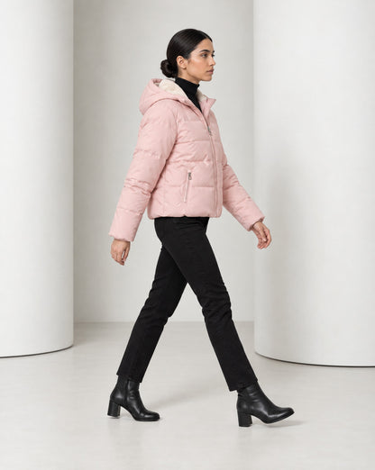 Side view of the Tove puffer in pink mid-stride, cropped length sitting at the hip