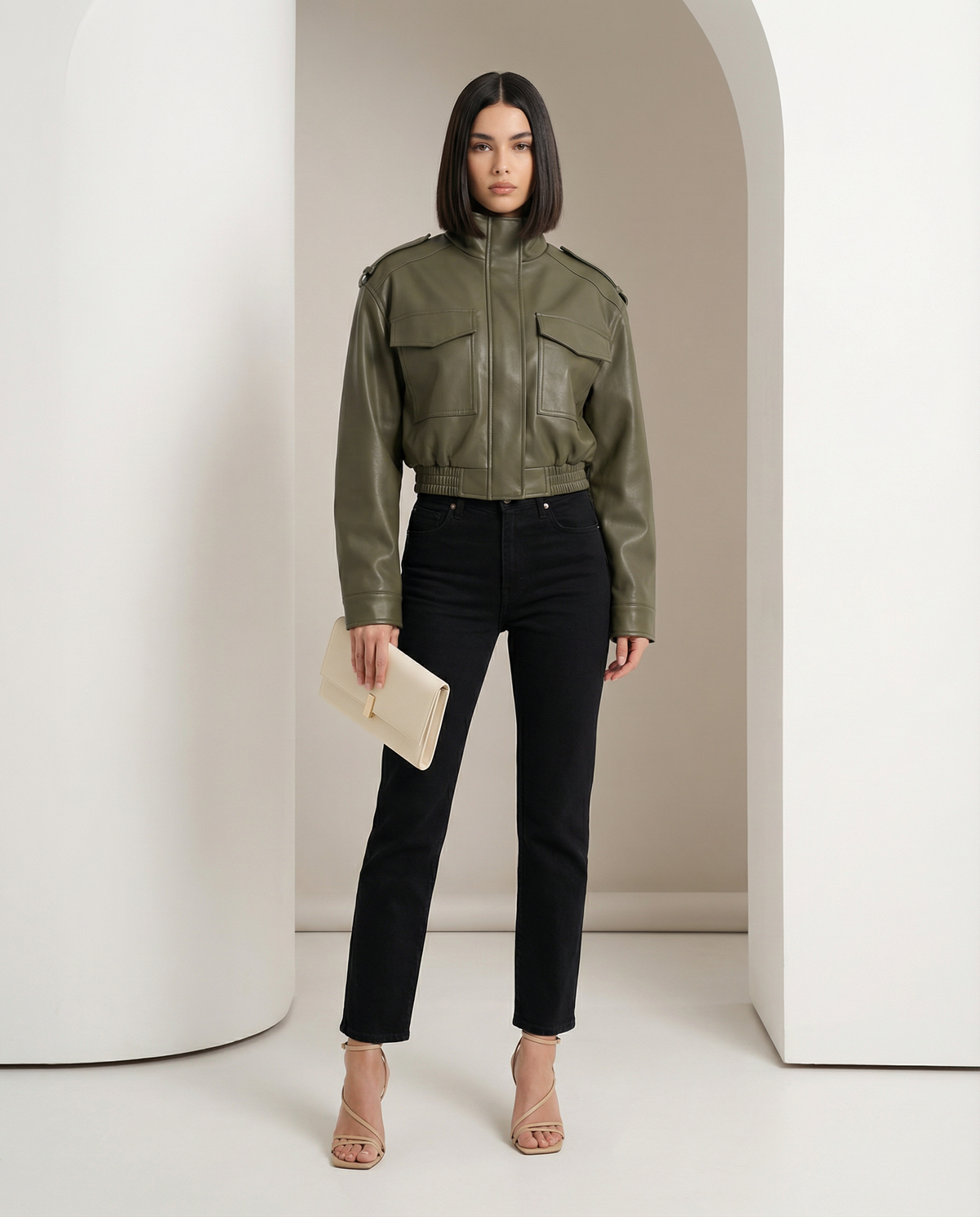 Olive green Veda cropped leather jacket with flap pockets and funnel neck over black jeans