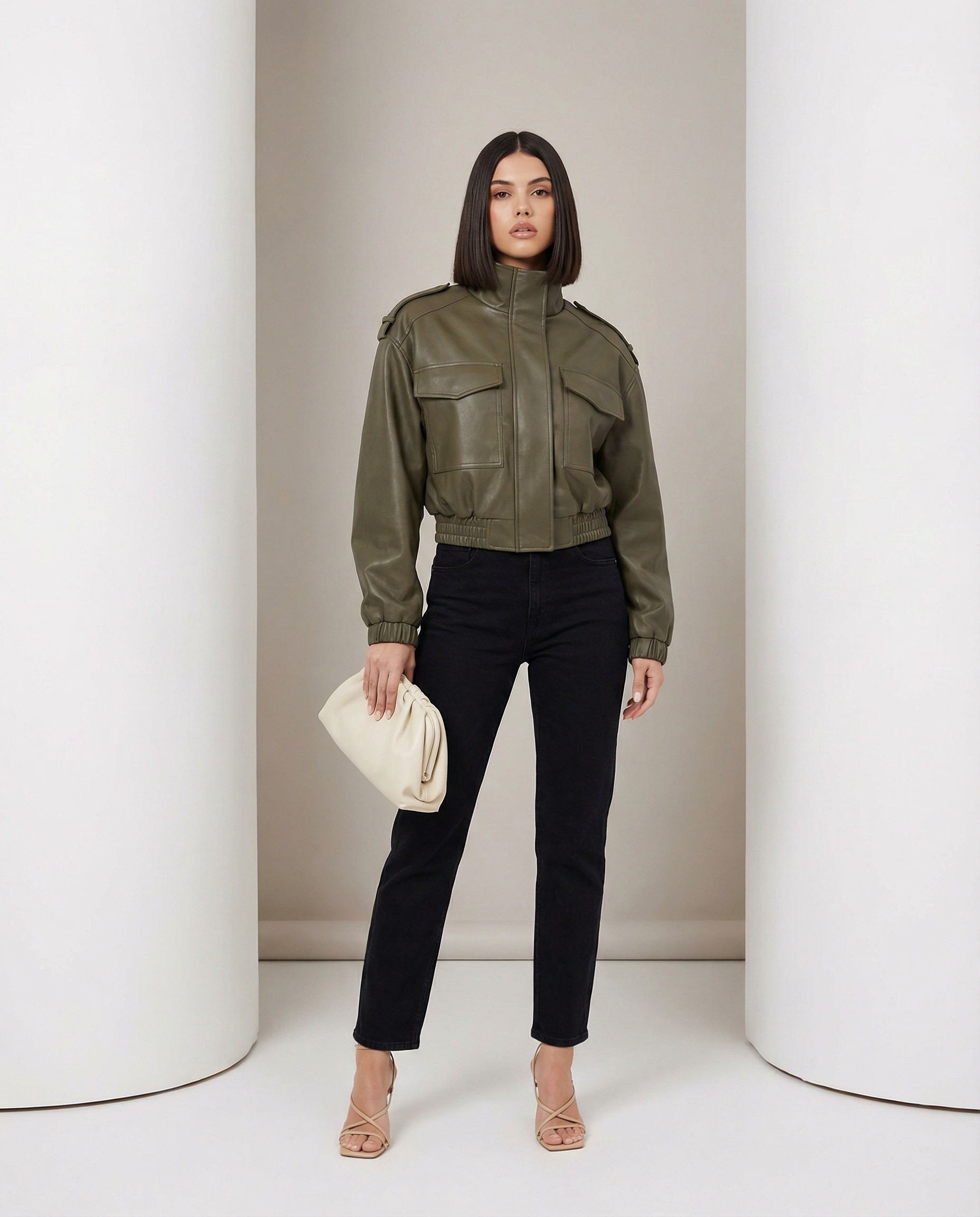 Olive leather bomber with boxy shoulders and chest flap pockets, worn with black straight jeans