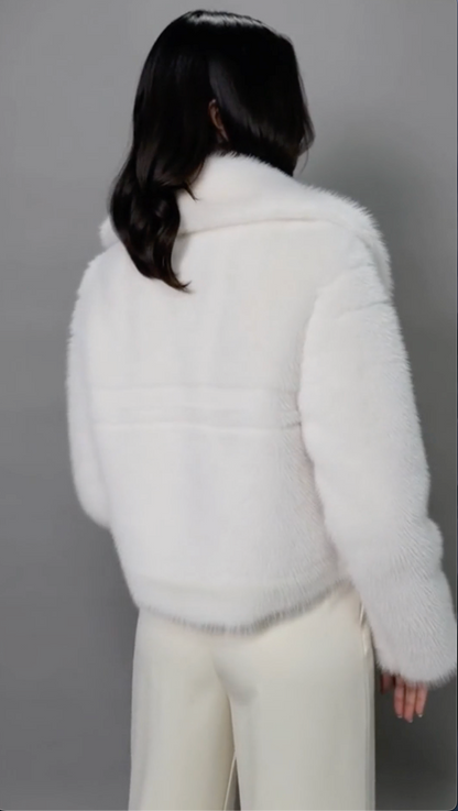 Back view of the ivory cropped faux-fur jacket showing the collar and centre back seam