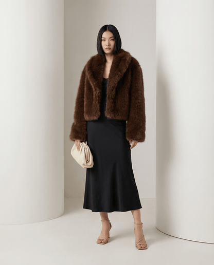 Vera faux-fur jacket in cocoa brown with a wide shawl collar, styled with a black bias midi skirt