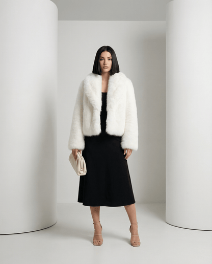 Ivory Vera faux-fur jacket worn open over a black midi dress, full length front view