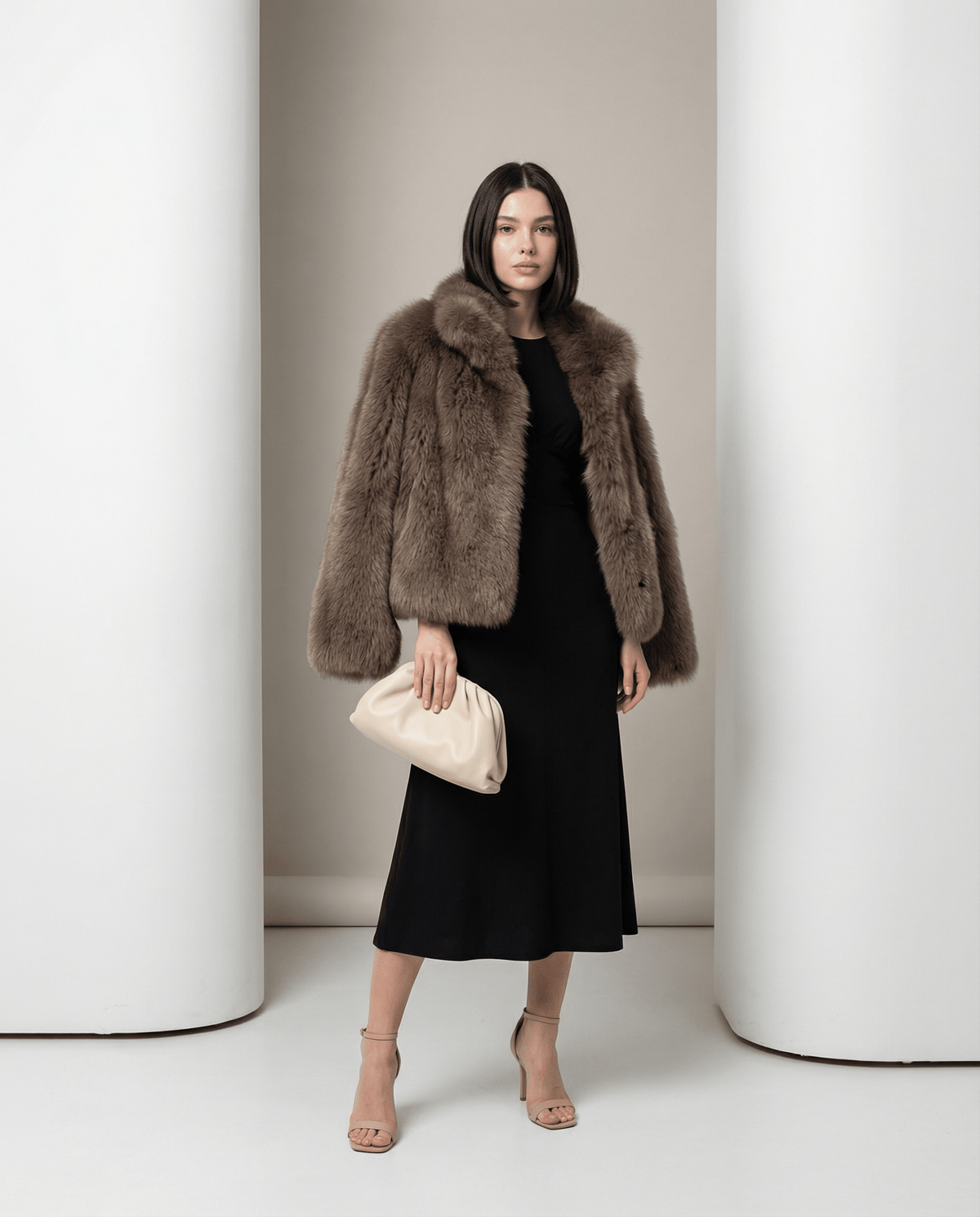Cropped taupe faux-fur jacket with a wide collar and full sleeves over a black midi dress