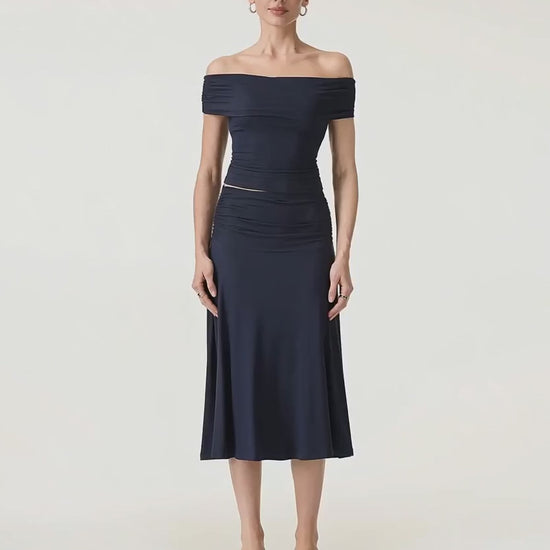 Video of the navy Hedda set turning slowly, the A-line midi skirt moving with her