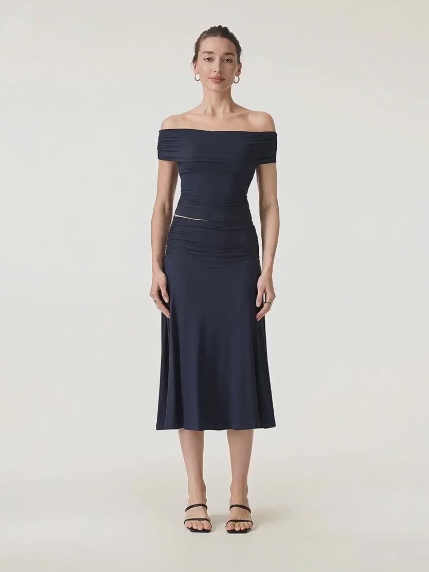 Video of the navy Hedda set turning slowly, the A-line midi skirt moving with her