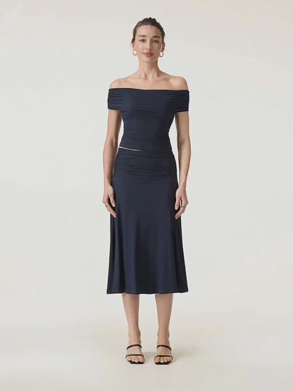 Video of the navy Hedda set turning slowly, the A-line midi skirt moving with her