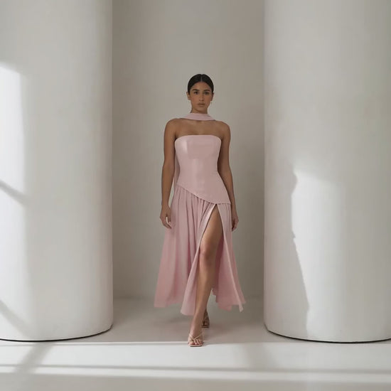 Short clip of the Embla blush chiffon maxi walking and turning to show the laced back