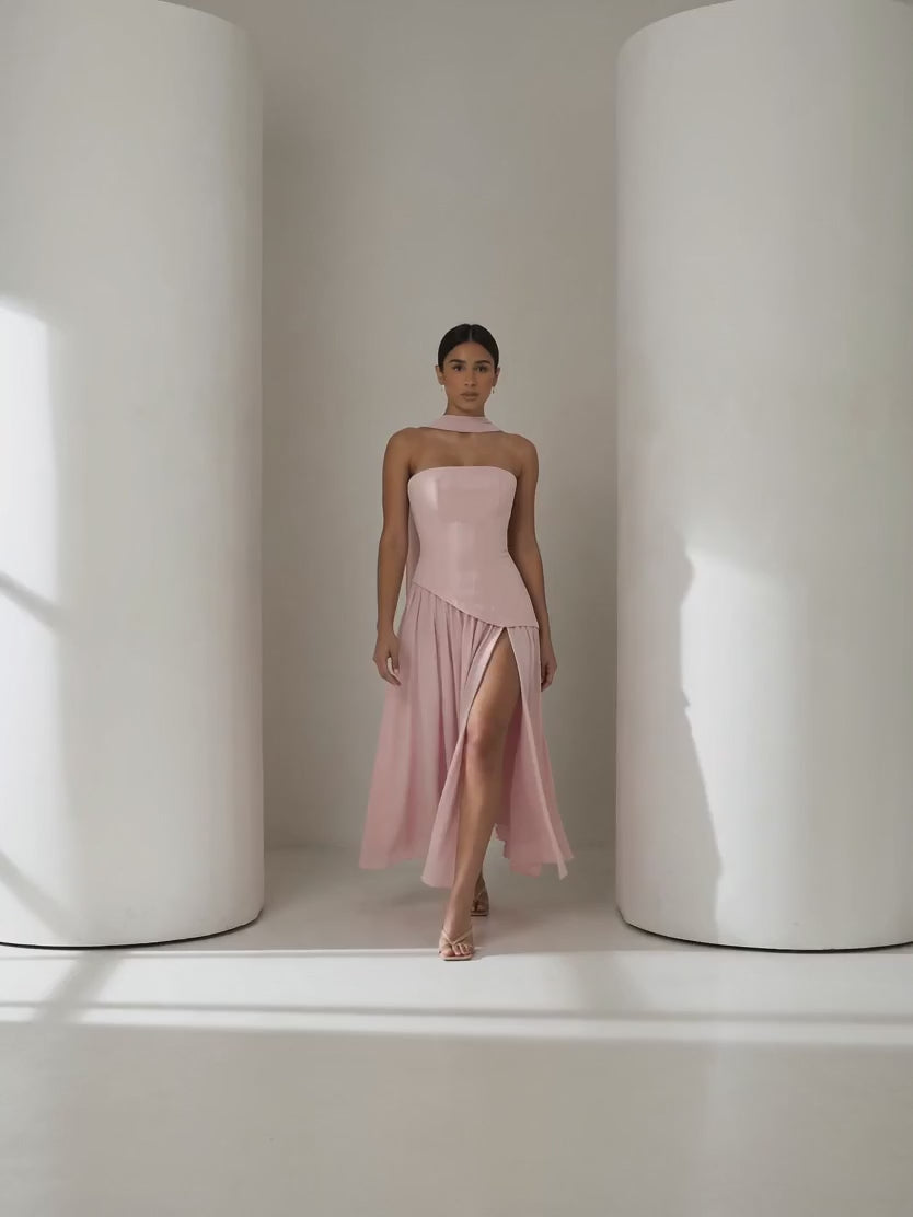 Short clip of the Embla blush chiffon maxi walking and turning to show the laced back